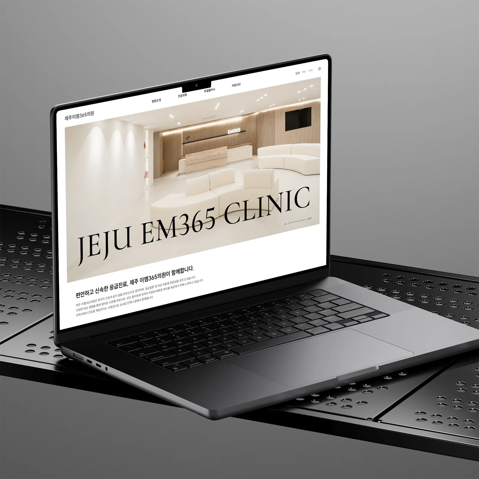 노트북 화면에 띄워진 제주이엠365의원 홈페이지 메인 디자인, 'JEJU EM365 CLINIC' 로고와 깨끗한 병원 로비 이미지가 담긴 웹사이트 레이아웃
